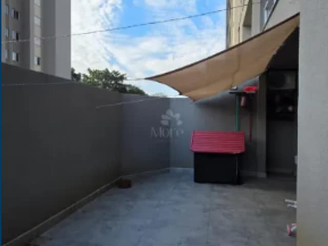 Área de serviço com piso de cimento queimado e toldo
